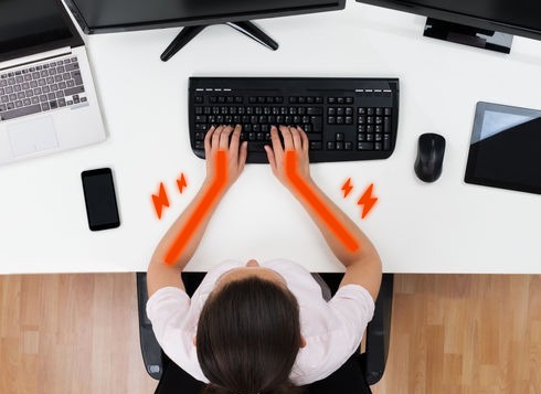 Demonstration of how the forearms tend to point inward, with the wrists sharply bent outward, while using a standard keyboard